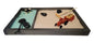 A Farm Zen Garden with a divided wooden tray, green and brown velvety sand, black rocks, a bamboo rake, and farm figurines.