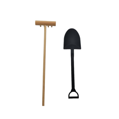 A bamboo rake and plastic shovel